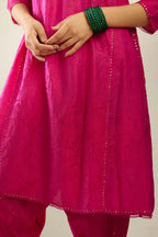 Silk hand crushed short kalidar kurta set with button placket, highlighted with gold sequins and embroidered scalloped organza at edges.