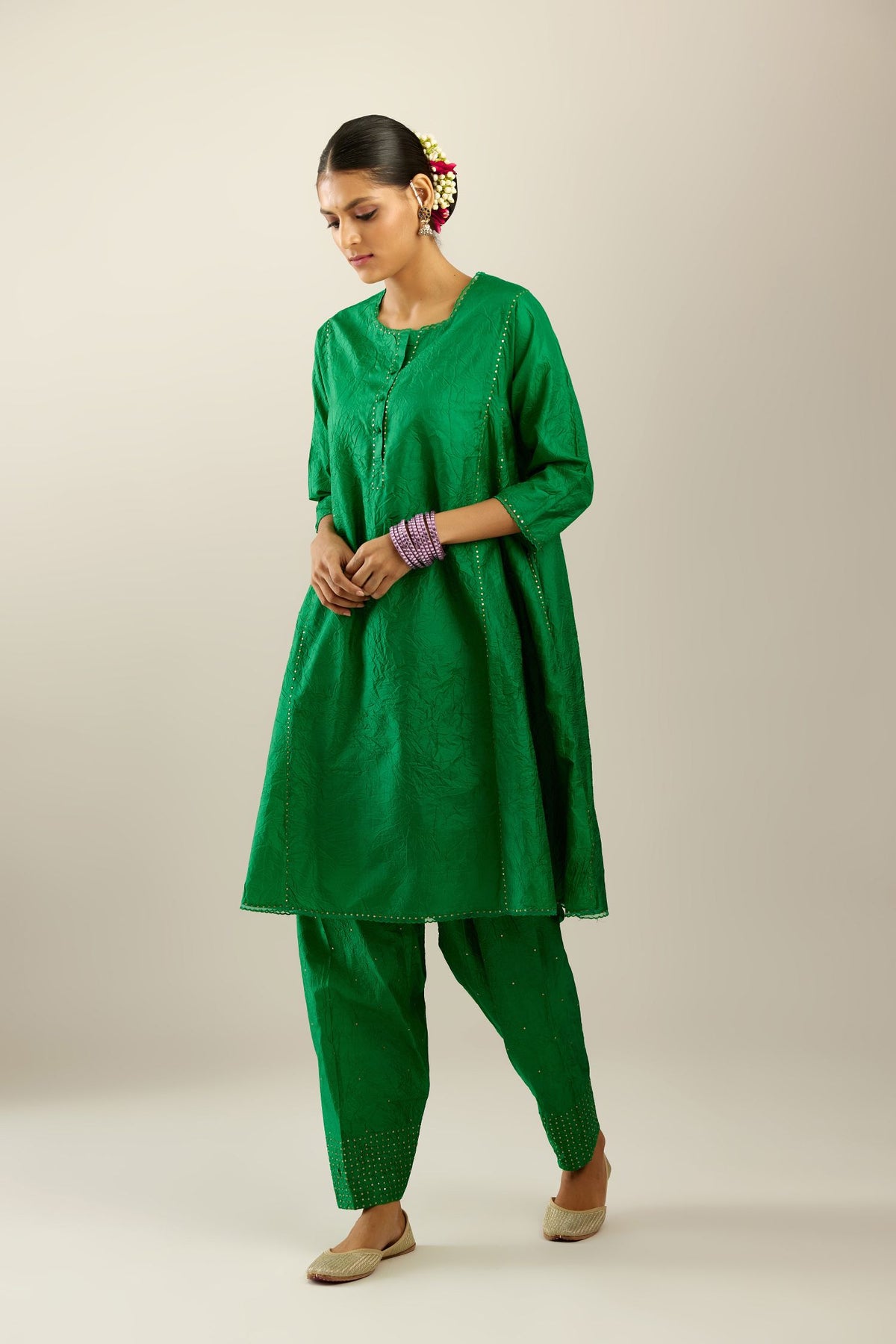Silk hand crushed short kalidar kurta set with button placket, highlighted with gold sequins and embroidered scalloped organza at edges.