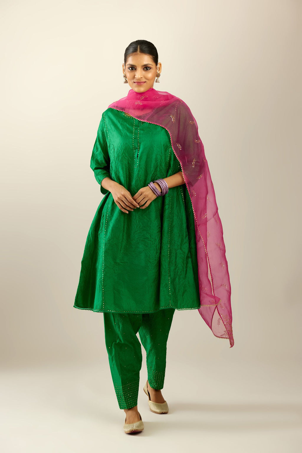 Silk hand crushed short kalidar kurta set with button placket, highlighted with gold sequins and embroidered scalloped organza at edges.