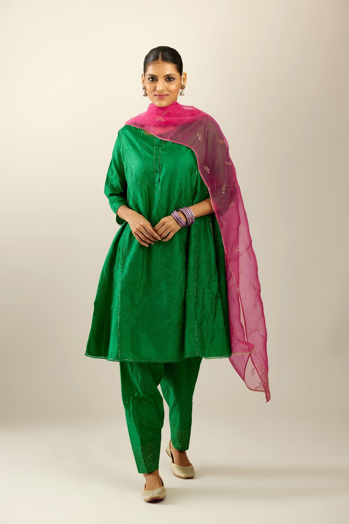 Silk hand crushed short kalidar kurta set with button placket, highlighted with gold sequins and embroidered scalloped organza at edges.