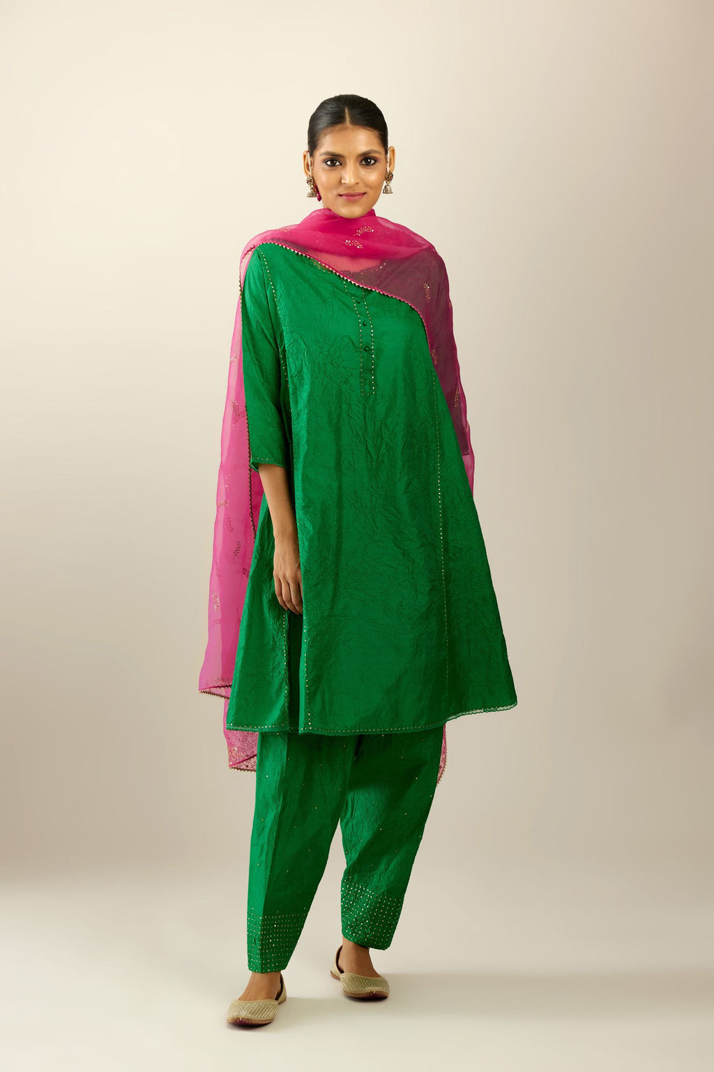 Silk hand crushed short kalidar kurta set with button placket, highlighted with gold sequins and embroidered scalloped organza at edges.