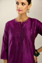 Silk hand crushed short kalidar kurta set with button placket, highlighted with gold sequins and embroidered scalloped organza at edges.