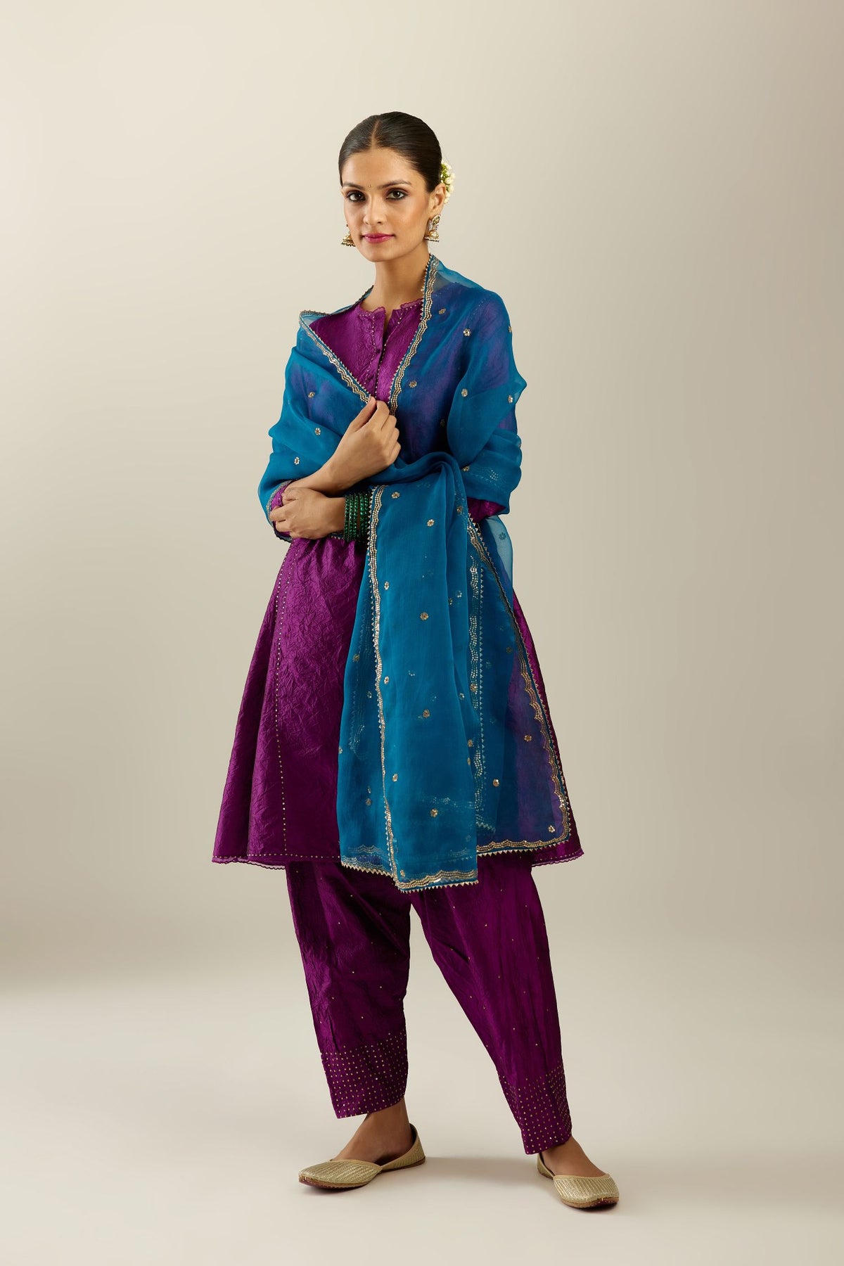 Silk hand crushed short kalidar kurta set with button placket, highlighted with gold sequins and embroidered scalloped organza at edges.