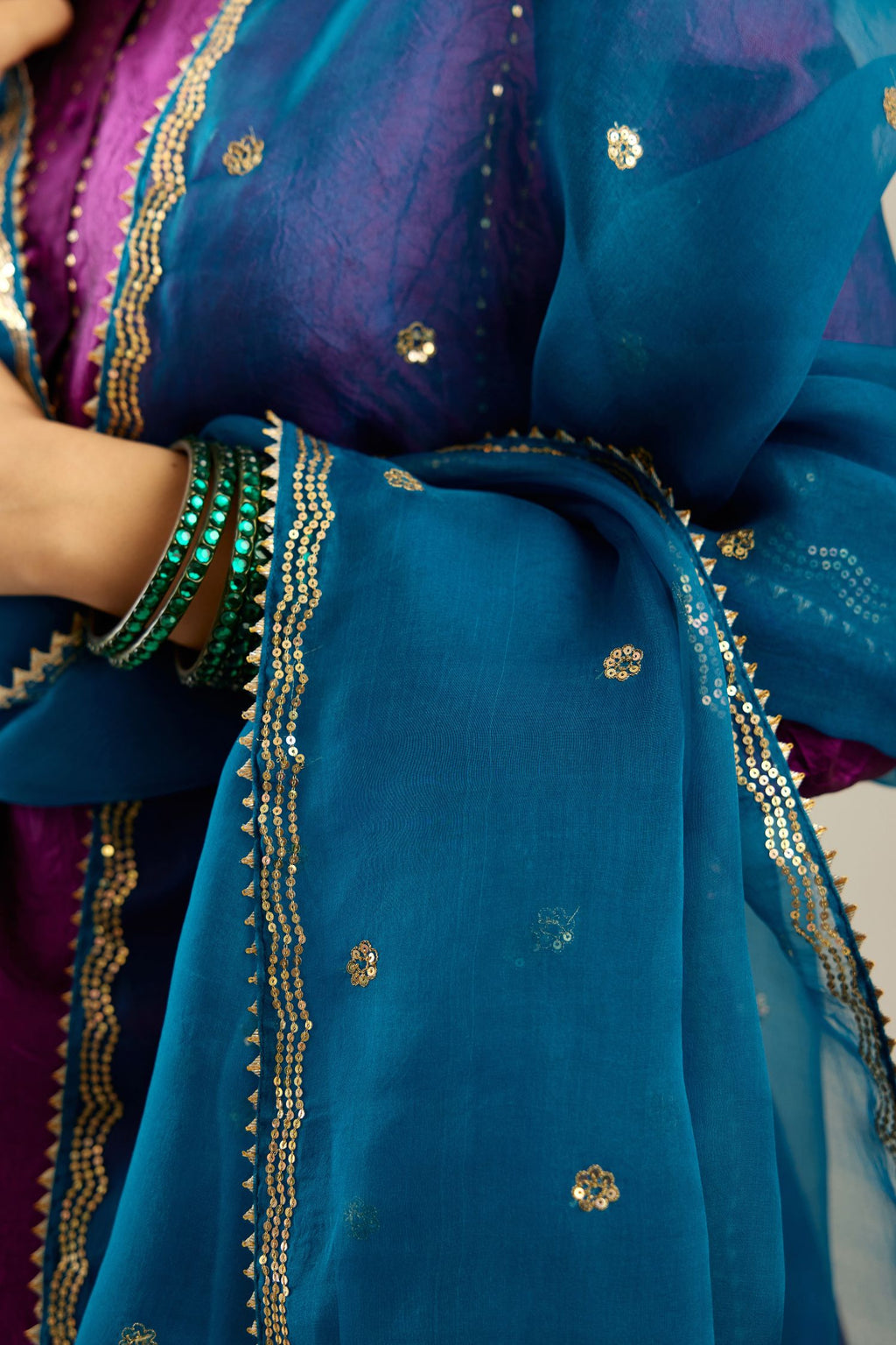 Dark teal silk organza dupatta with golden sequins butis all over with a sequined scalloped edge.