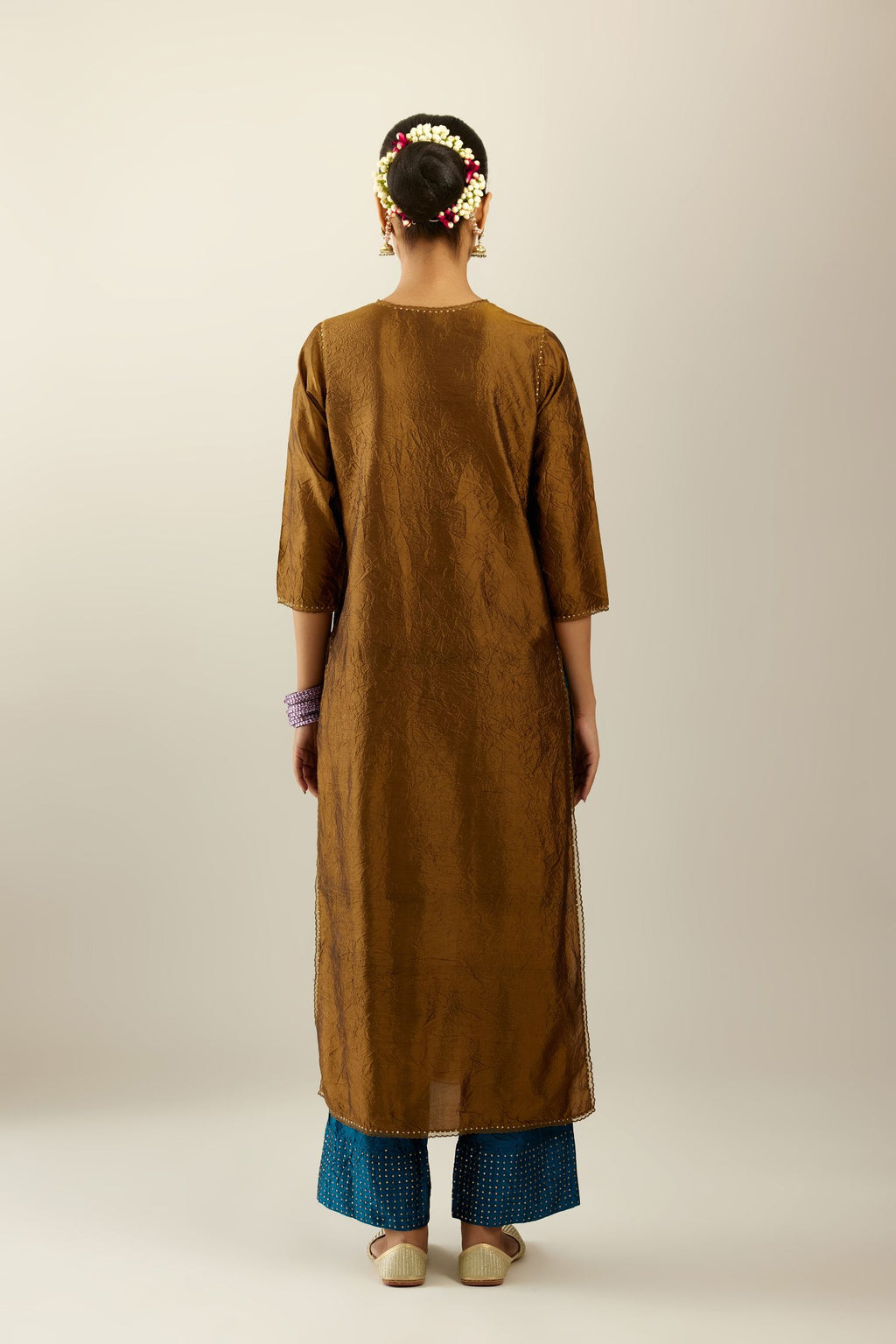 Golden olive silk straight kurta set, highlighted with organza and sequins at edges.