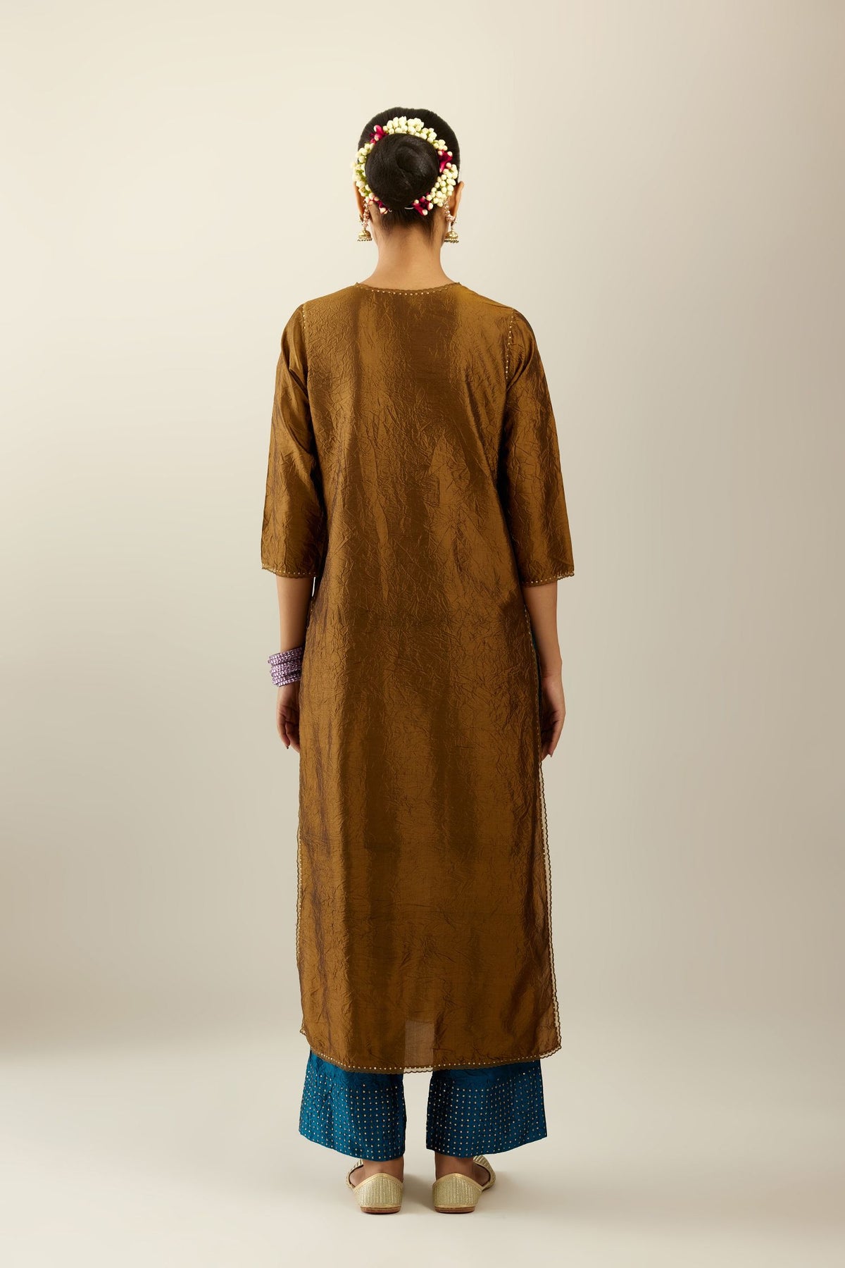 Golden olive silk straight kurta set, highlighted with organza and sequins at edges.