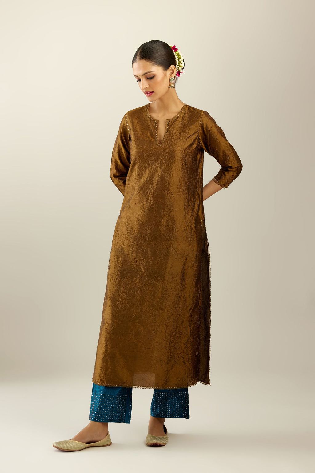 Golden olive silk straight kurta set, highlighted with organza and sequins at edges.