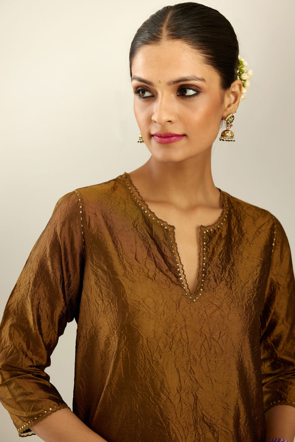 Golden olive silk straight kurta set, highlighted with organza and sequins at edges.