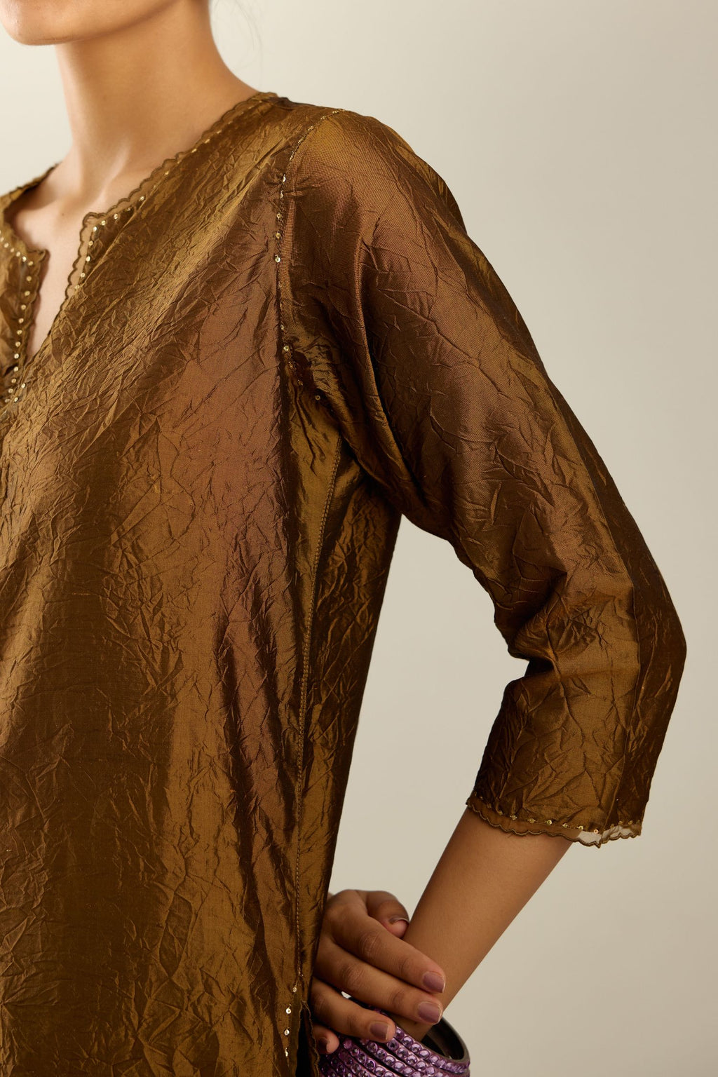 Golden olive silk straight kurta set, highlighted with organza and sequins at edges.