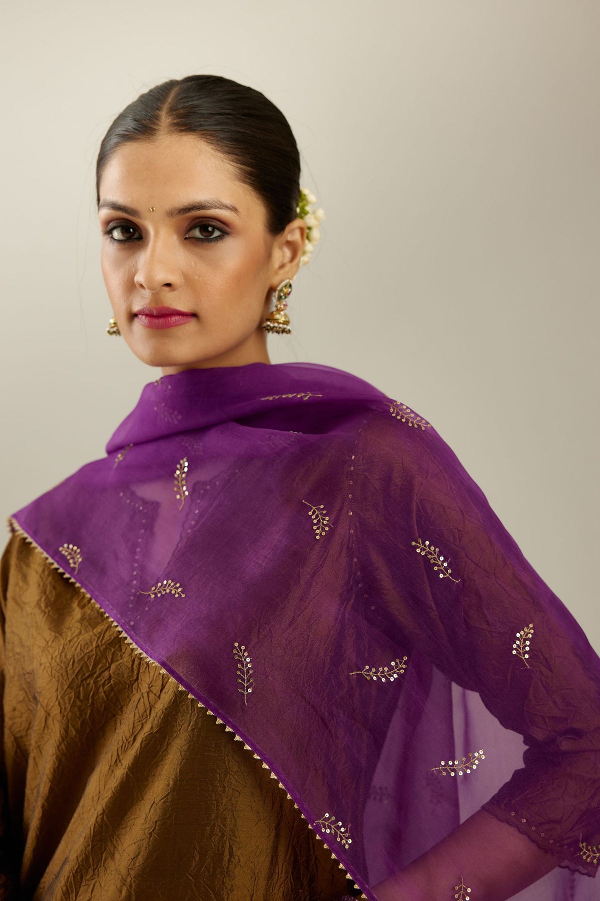 Golden olive silk straight kurta set, highlighted with organza and sequins at edges.