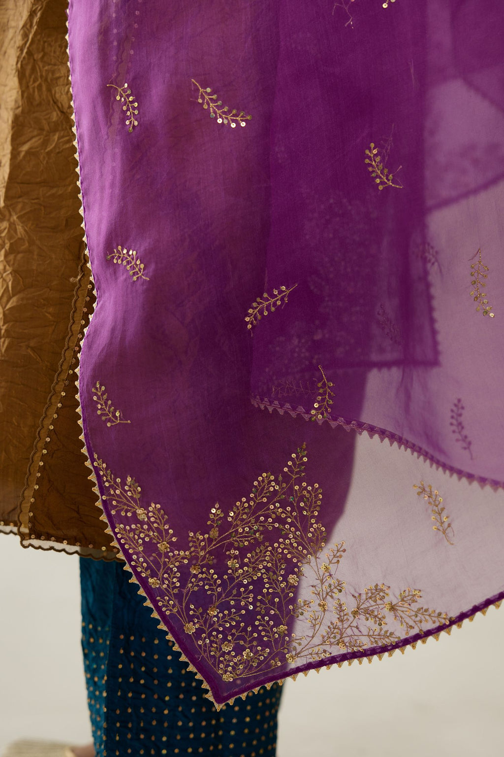 Golden olive silk straight kurta set, highlighted with organza and sequins at edges.