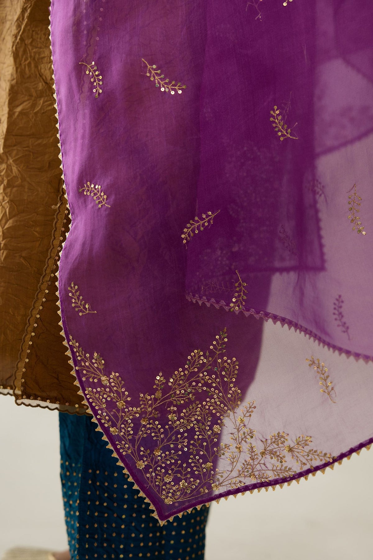 Golden olive silk straight kurta set, highlighted with organza and sequins at edges.