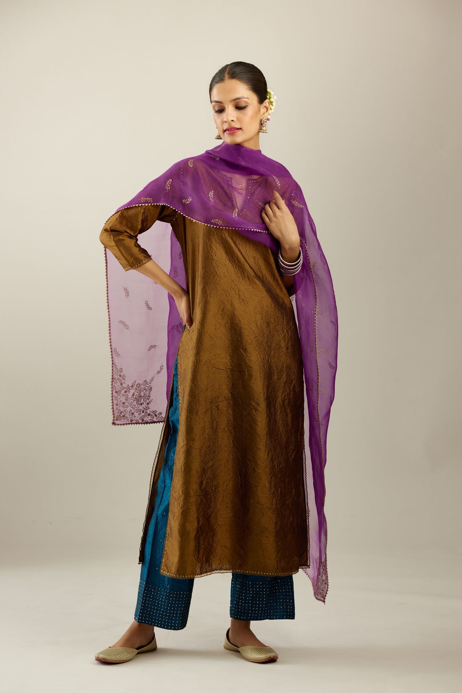 Golden olive silk straight kurta set, highlighted with organza and sequins at edges.