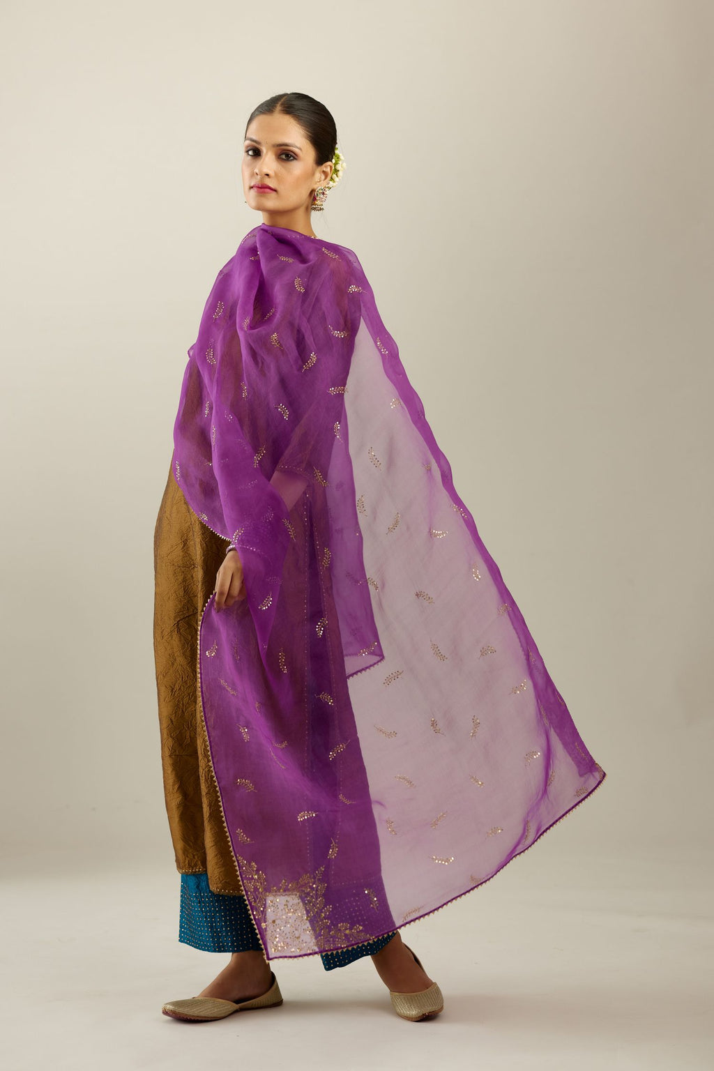 Golden olive silk straight kurta set, highlighted with organza and sequins at edges.
