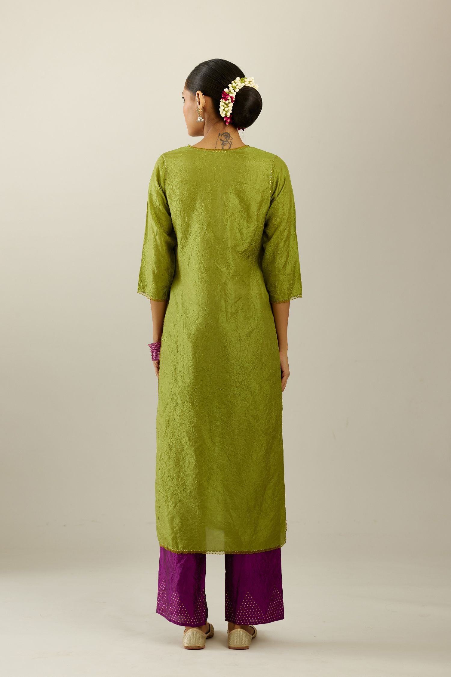 Apple green silk straight kurta set, highlighted with organza and sequins at edges.