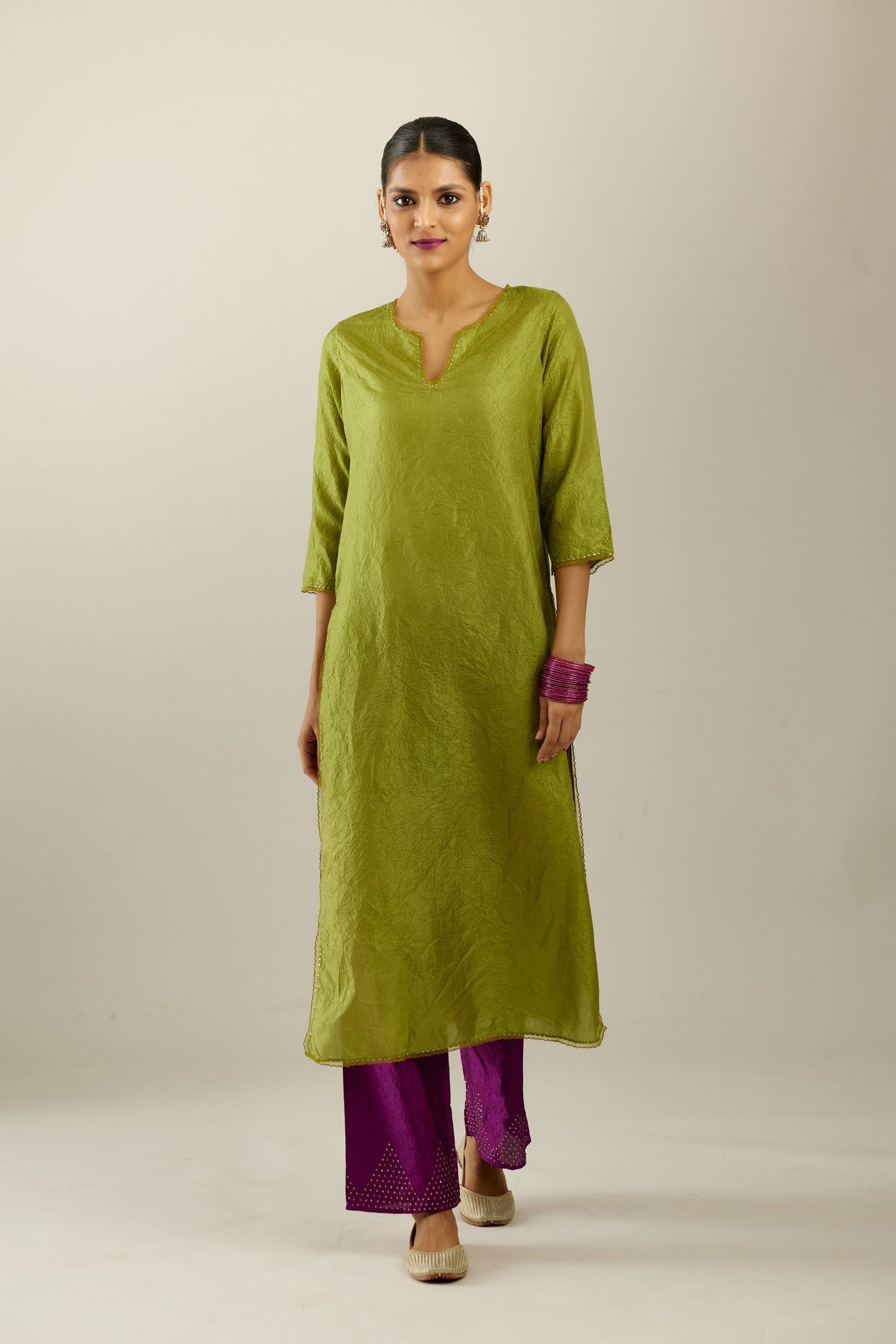 Apple green silk straight kurta set, highlighted with organza and sequins at edges.