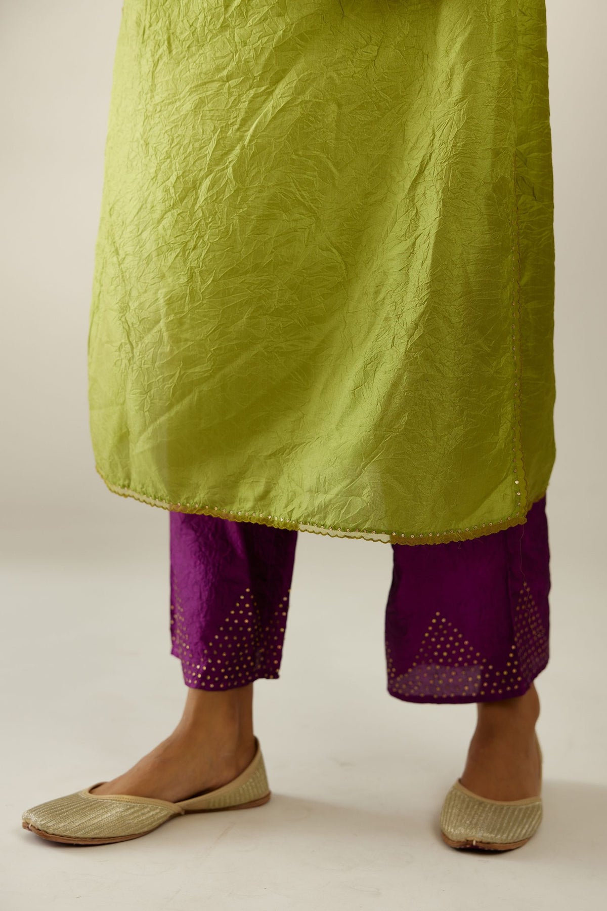 Apple green silk straight kurta set, highlighted with organza and sequins at edges.
