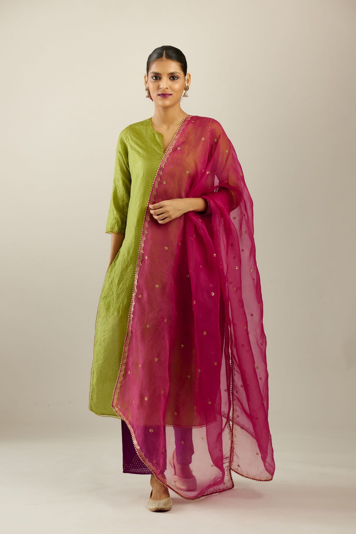 Apple green silk straight kurta set, highlighted with organza and sequins at edges.
