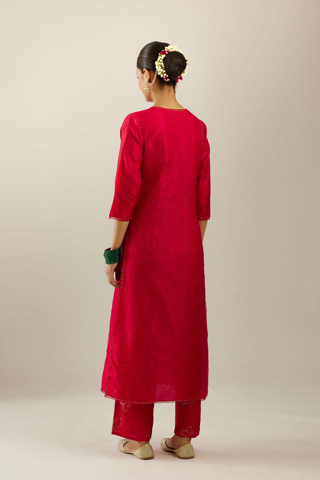 Red silk straight kurta set, highlighted with organza and sequins at edges.