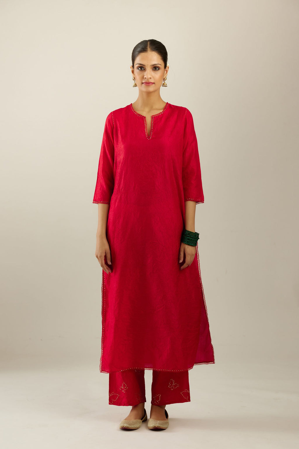 Red silk straight kurta set, highlighted with organza and sequins at edges.