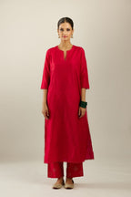Red silk straight kurta set, highlighted with organza and sequins at edges.