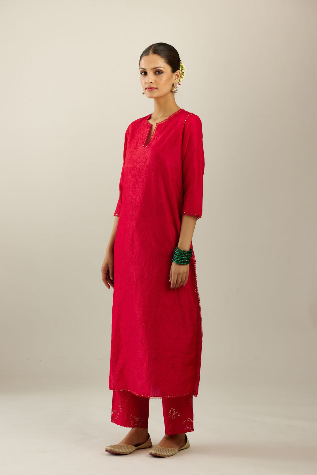 Red silk straight kurta set, highlighted with organza and sequins at edges.