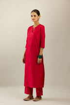 Red silk straight kurta set, highlighted with organza and sequins at edges.