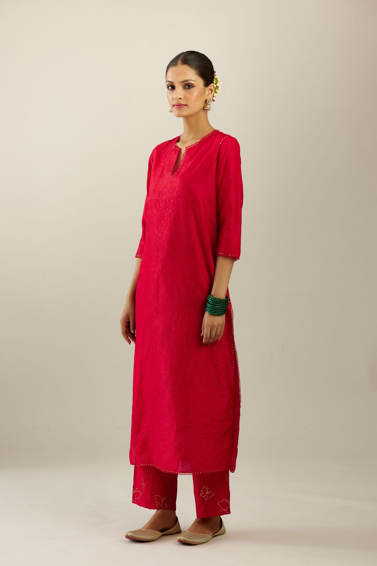 Red silk straight kurta set, highlighted with organza and sequins at edges.