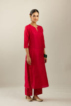 Red silk straight kurta set, highlighted with organza and sequins at edges.