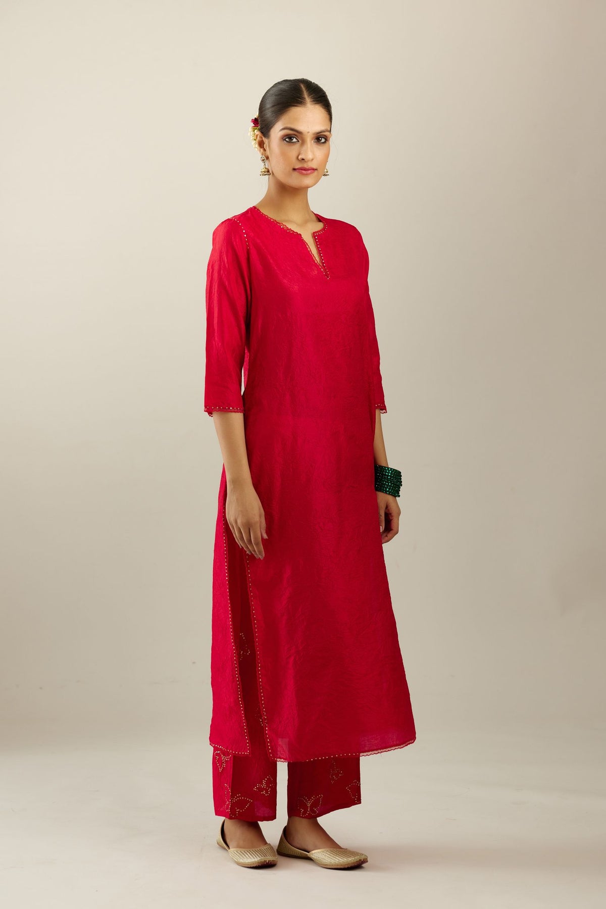 Red silk straight kurta set, highlighted with organza and sequins at edges.