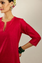 Red silk straight kurta set, highlighted with organza and sequins at edges.