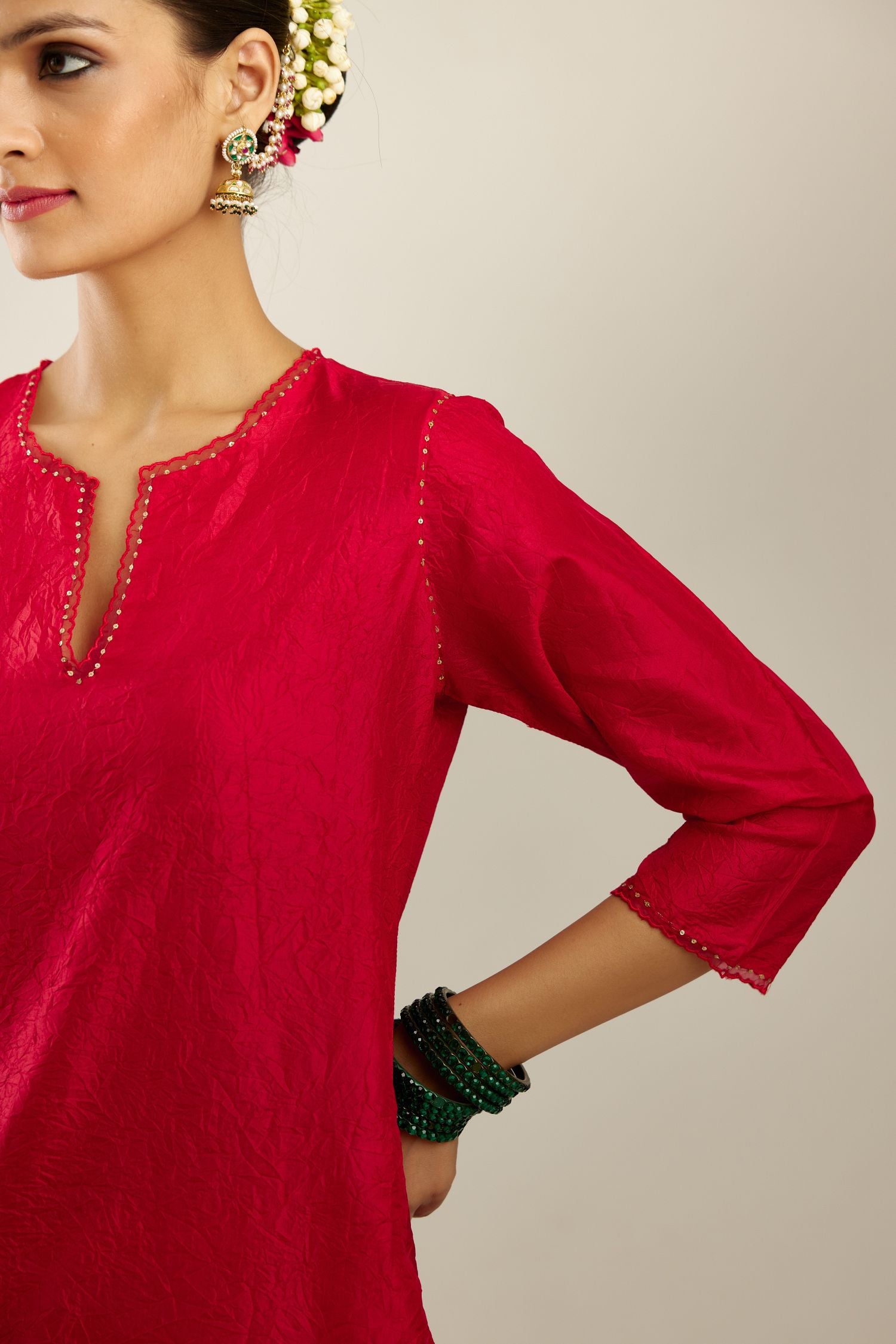 Red silk straight kurta set, highlighted with organza and sequins at edges.