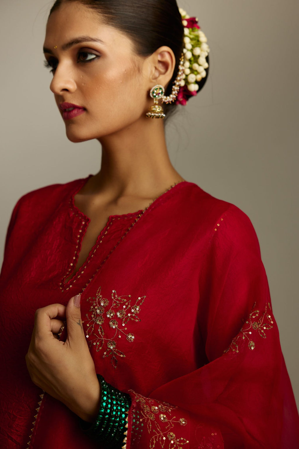 Red silk straight kurta set, highlighted with organza and sequins at edges.