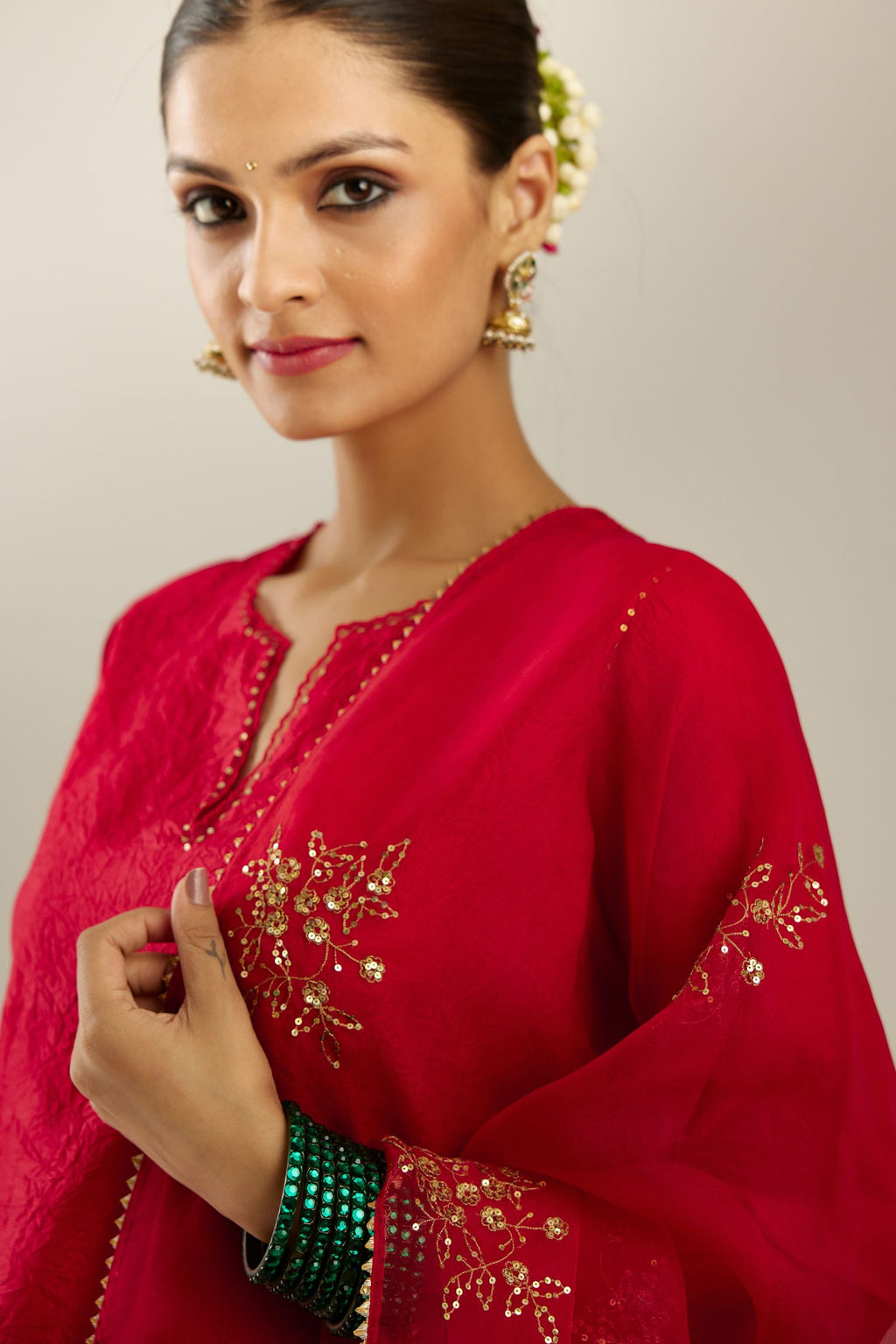 Red silk straight kurta set, highlighted with organza and sequins at edges.
