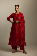 Red silk straight kurta set, highlighted with organza and sequins at edges.