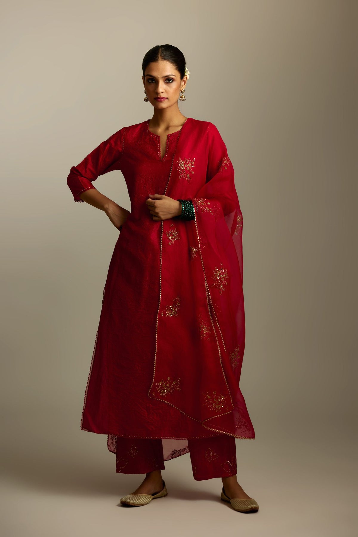 Red silk straight kurta set, highlighted with organza and sequins at edges.
