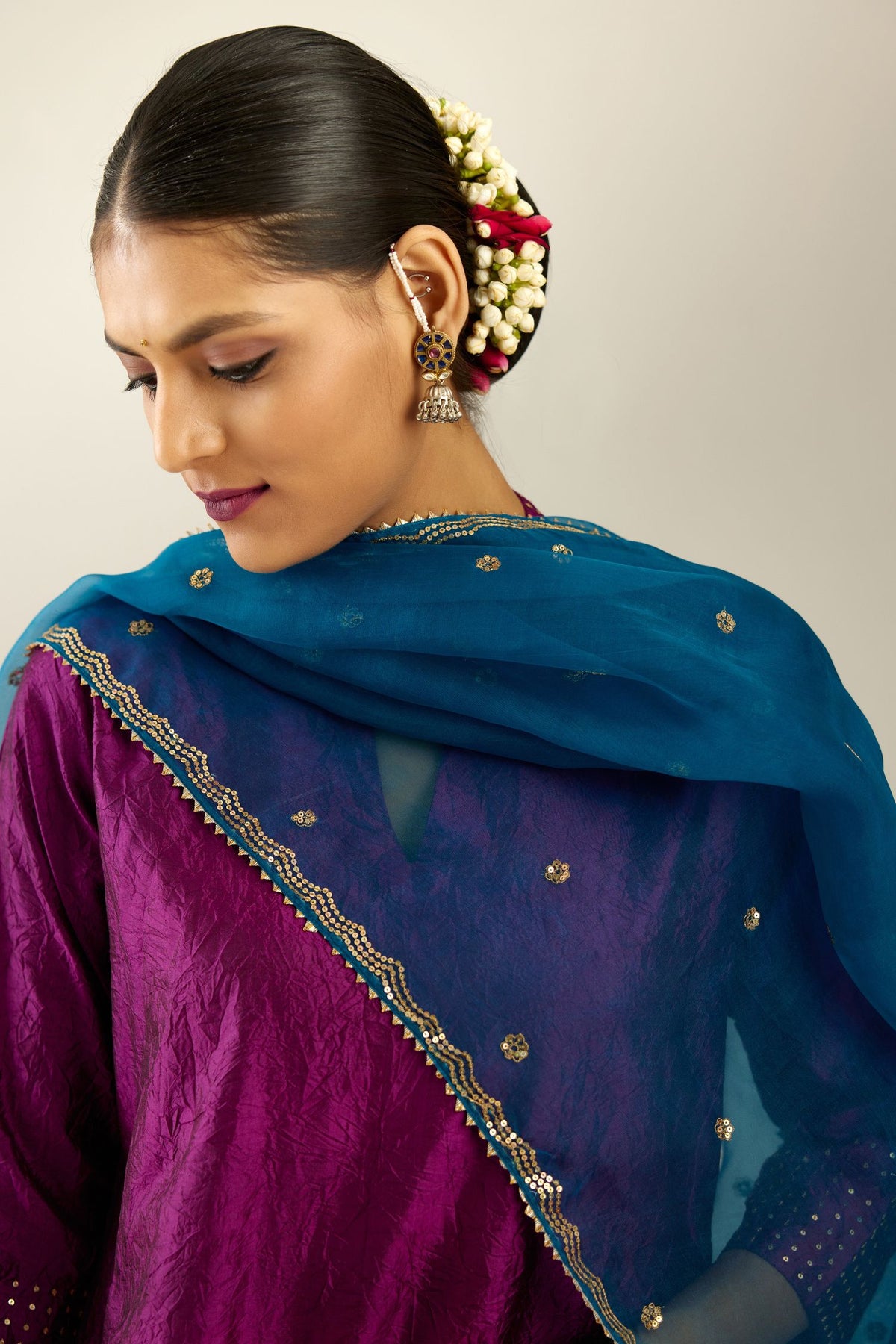 Dark teal silk organza dupatta with golden sequins butis all over with a sequined scalloped edge.