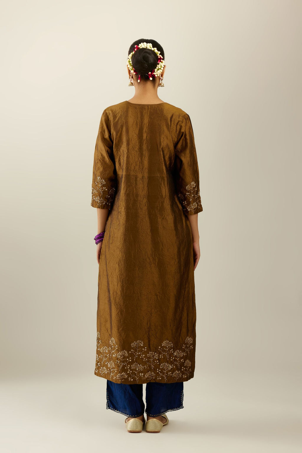 Golden olive hand crushed silk straight kurta set, highlighted with zari and sequins work at sleeve and hem.