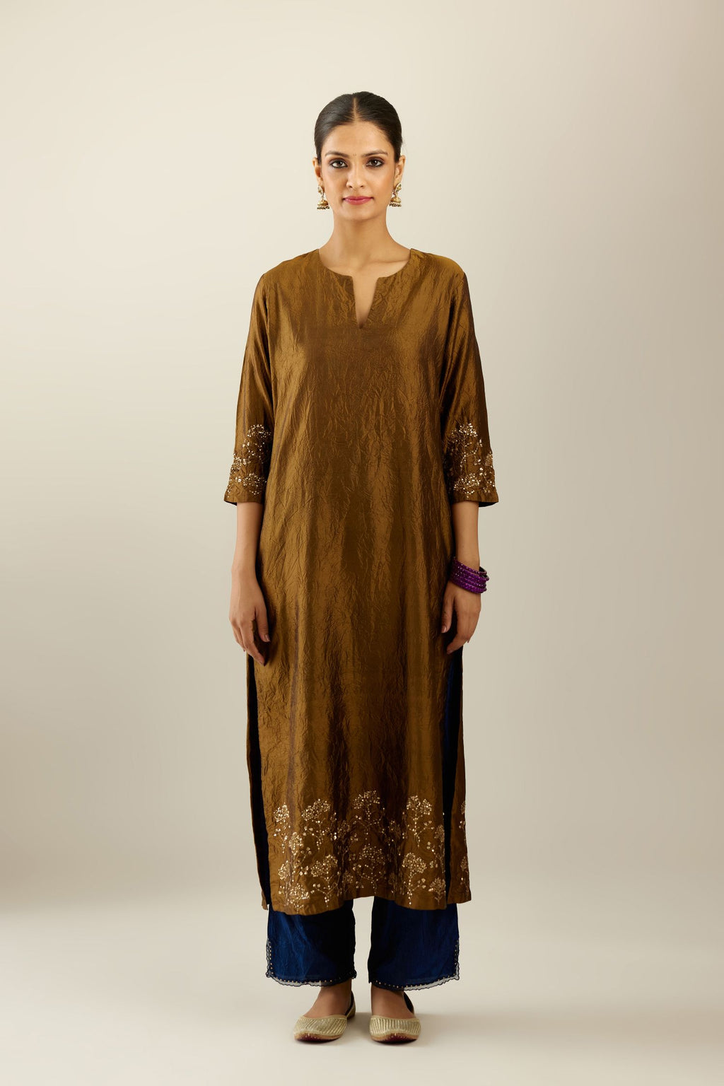 Golden olive hand crushed silk straight kurta set, highlighted with zari and sequins work at sleeve and hem.