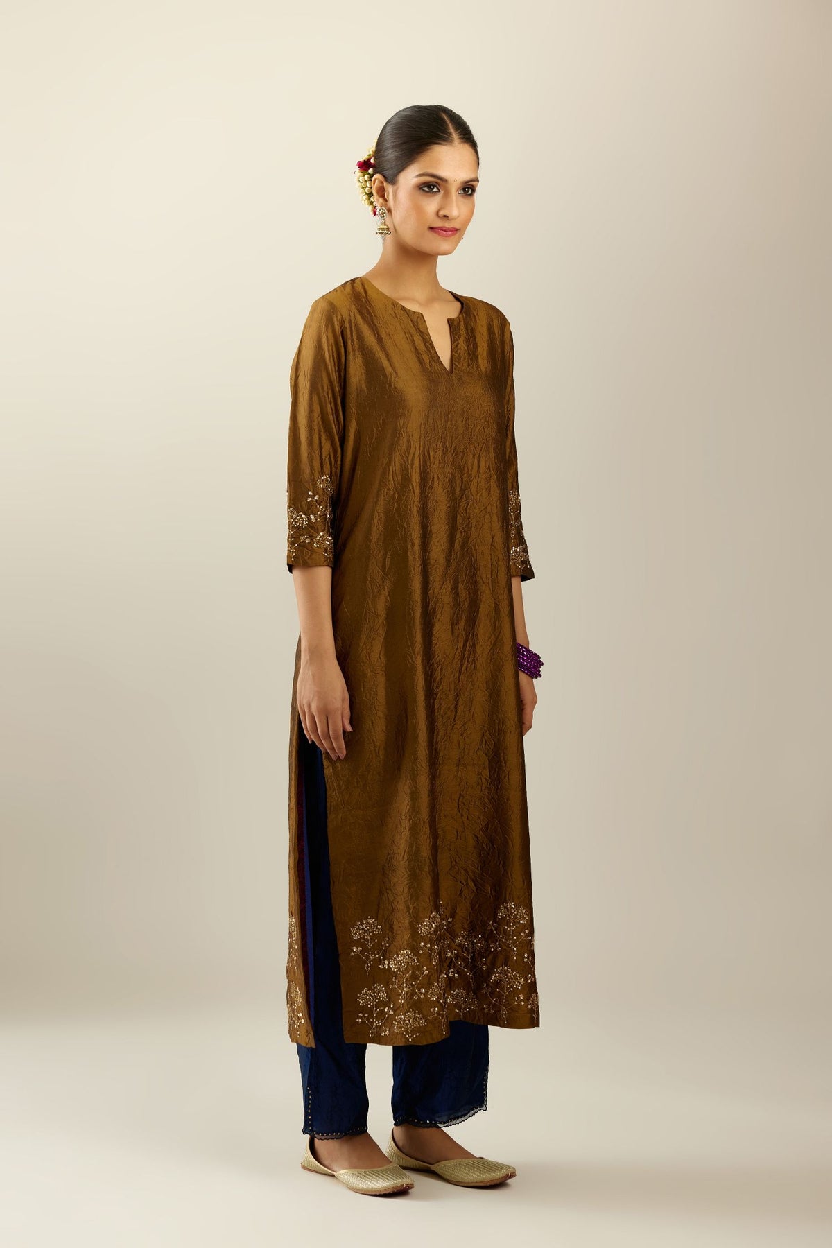 Golden olive hand crushed silk straight kurta set, highlighted with zari and sequins work at sleeve and hem.