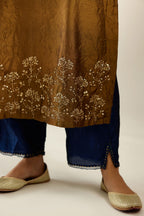 Golden olive hand crushed silk straight kurta set, highlighted with zari and sequins work at sleeve and hem.