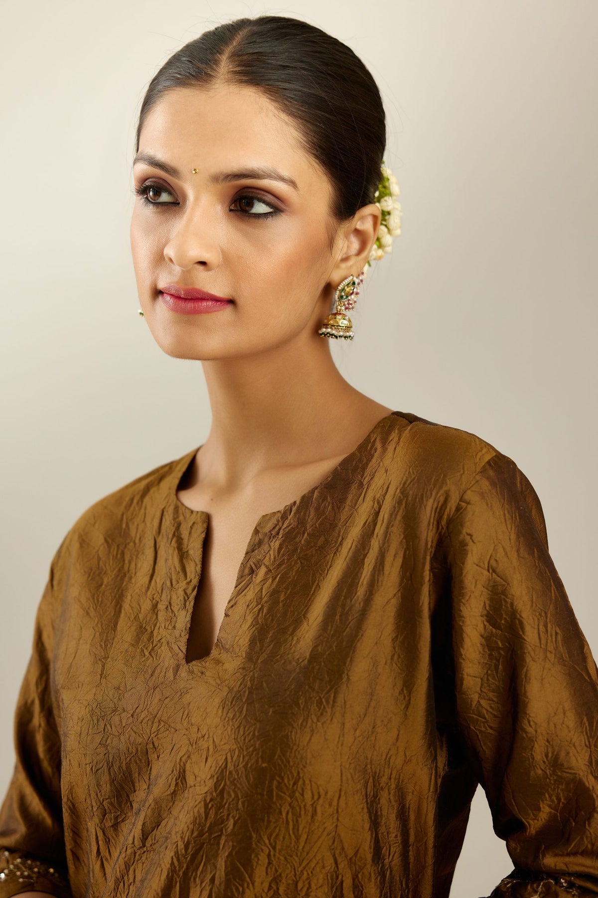 Golden olive hand crushed silk straight kurta set, highlighted with zari and sequins work at sleeve and hem.