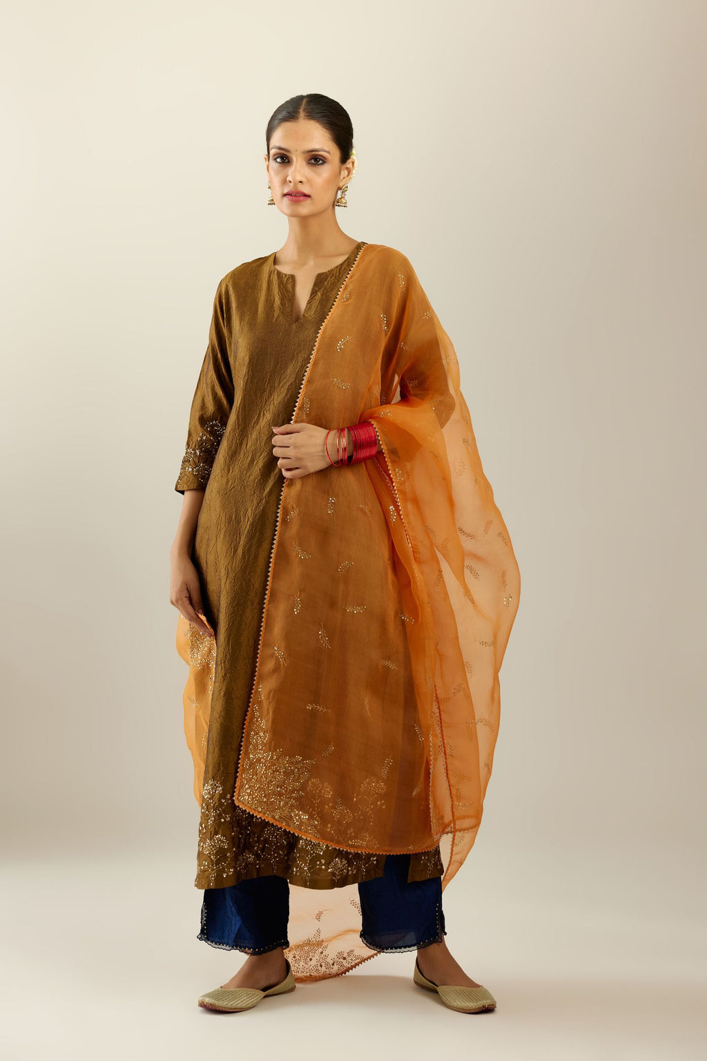 Golden olive hand crushed silk straight kurta set, highlighted with zari and sequins work at sleeve and hem.