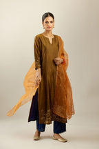Golden olive hand crushed silk straight kurta set, highlighted with zari and sequins work at sleeve and hem.