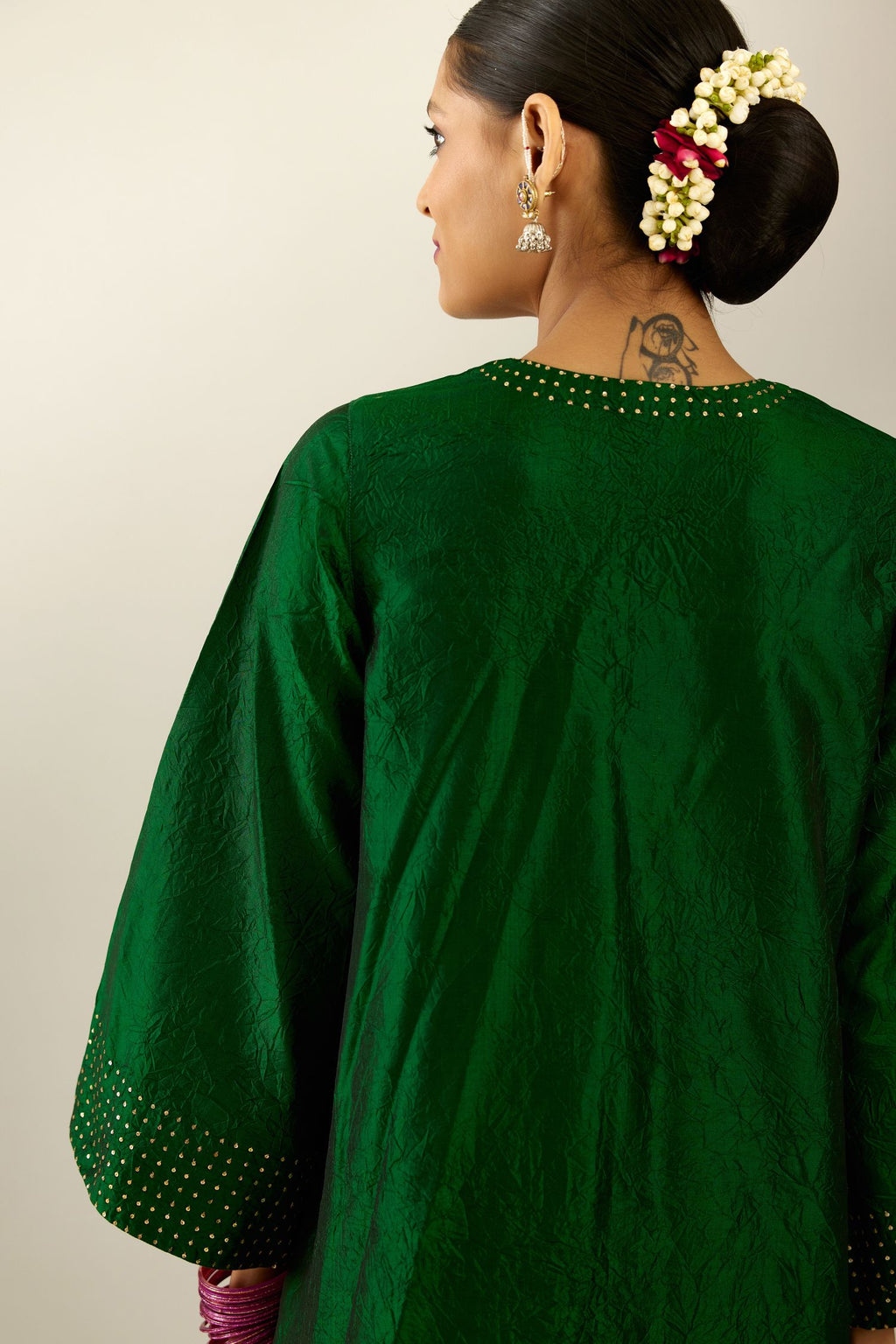 Dark green silk hand crushed easy fit straight hem kurta set, highlighted with a broad gold sequins border at hem.