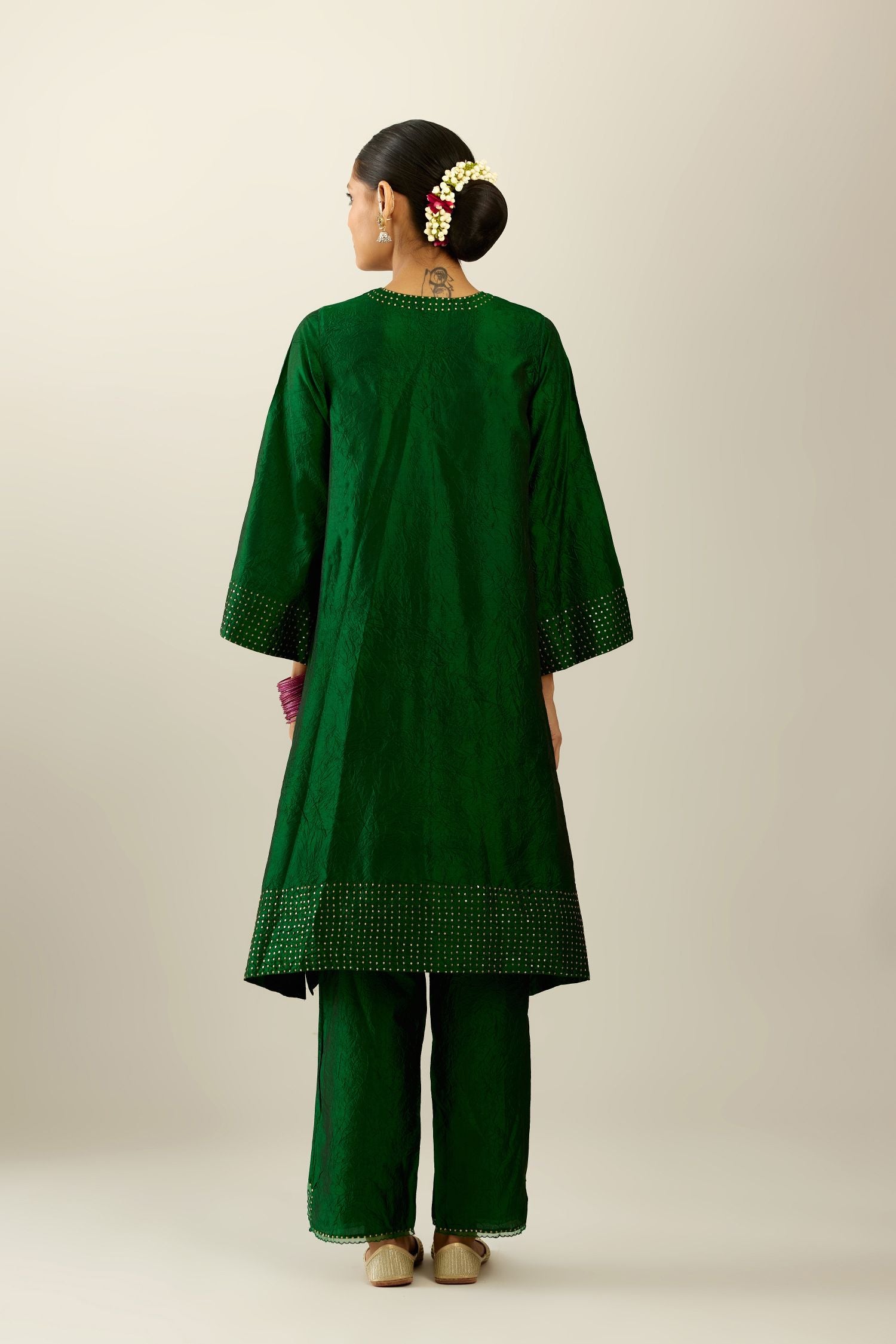 Dark green silk hand crushed easy fit straight hem kurta set, highlighted with a broad gold sequins border at hem.