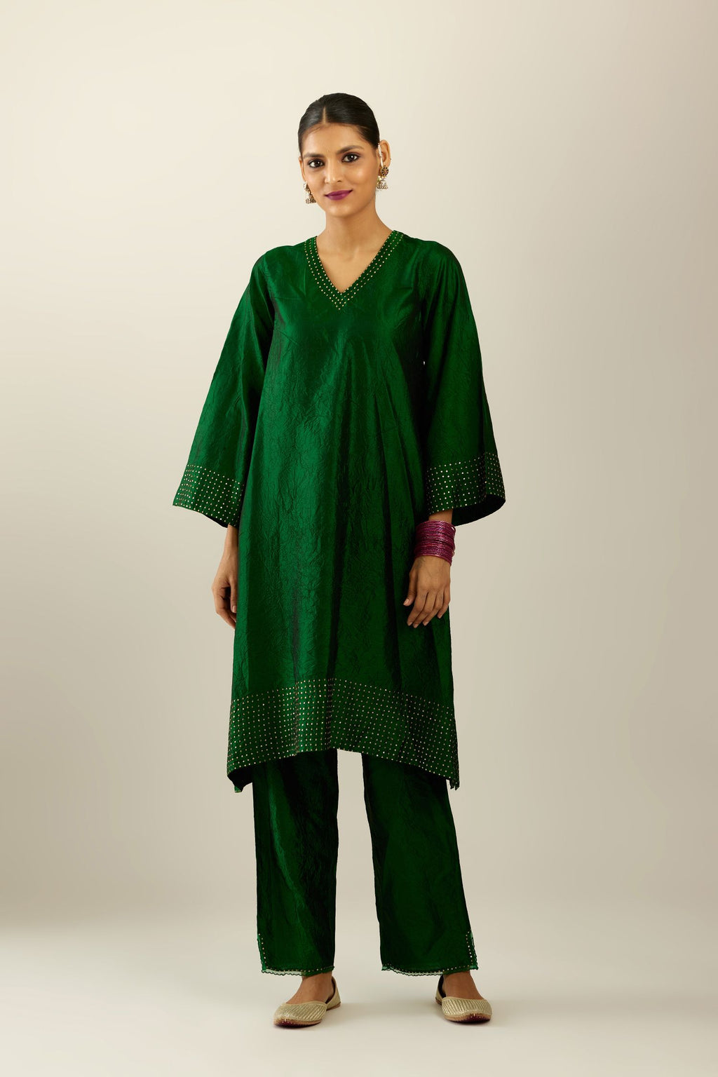 Dark green silk hand crushed easy fit straight hem kurta set, highlighted with a broad gold sequins border at hem.