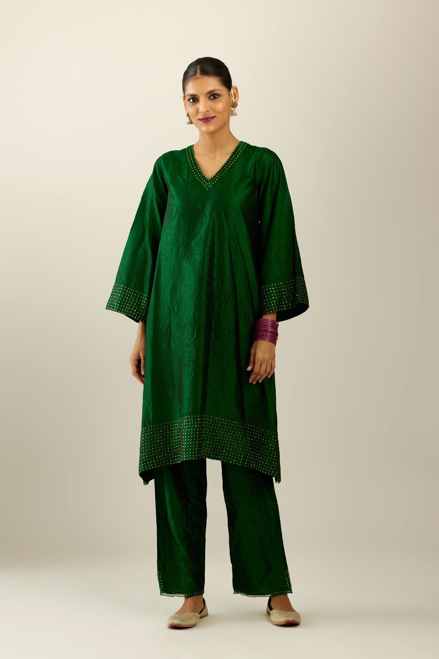 Dark green silk hand crushed easy fit straight hem kurta set, highlighted with a broad gold sequins border at hem.