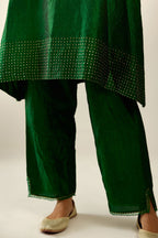 Dark green silk hand crushed easy fit straight hem kurta set, highlighted with a broad gold sequins border at hem.