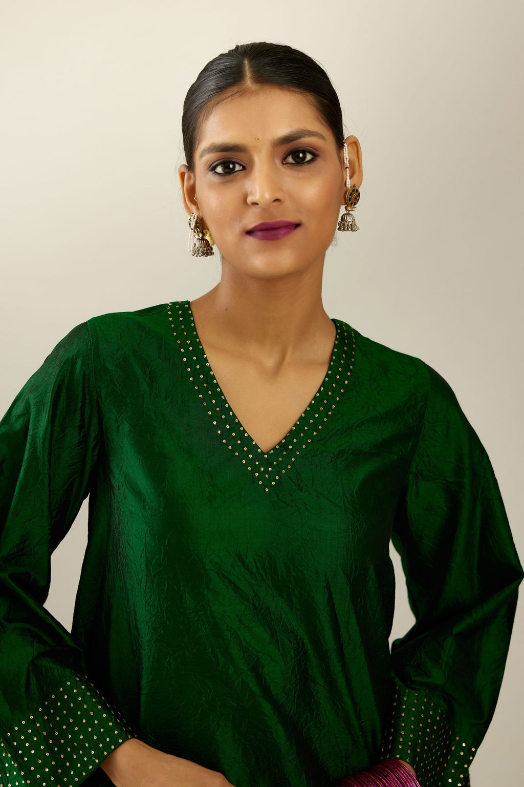 Dark green silk hand crushed easy fit straight hem kurta set, highlighted with a broad gold sequins border at hem.
